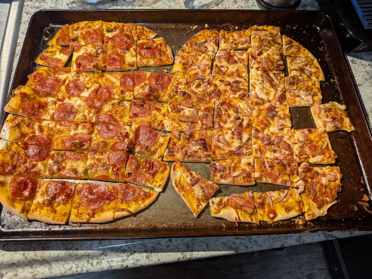 Two tavern-style sourdough pizzas cut into the classic small rectangular squares - pepperoni-cowboy-candy on the left, smoked chicken-bacon-red-onion on the right